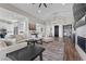 Spacious living room with modern decor, fireplace and seamless flow into the kitchen and dining spaces at 7520 Darian Jane St, Las Vegas, NV 89149