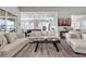 Bright and airy living room with modern decor and an open floor plan connecting to the kitchen at 7520 Darian Jane St, Las Vegas, NV 89149