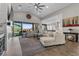 Open-concept living area featuring a high ceiling, ceiling fan, and a seamless connection to the kitchen at 7520 Darian Jane St, Las Vegas, NV 89149