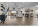 Open-concept living room with hardwood floors, modern decor, and an easy transition to the kitchen and dining area at 7520 Darian Jane St, Las Vegas, NV 89149