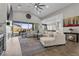 Open-concept living area featuring a high ceiling, ceiling fan, and a seamless connection to the kitchen at 7520 Darian Jane St, Las Vegas, NV 89149