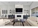 Bright living room with a fireplace, TV, floating shelves, and modern furniture at 7520 Darian Jane St, Las Vegas, NV 89149