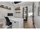 Home office with a modern desk, shelving, decor, and natural light; perfect for remote work and study at 7520 Darian Jane St, Las Vegas, NV 89149