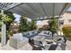 Inviting outdoor living space features a fire pit and comfortable seating under a pergola at 7520 Darian Jane St, Las Vegas, NV 89149