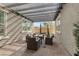 Charming covered patio with comfortable seating and stylish outdoor decor at 7520 Darian Jane St, Las Vegas, NV 89149