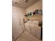 Functional laundry room with washer, dryer, and storage shelves at 85 Day Trade St # 2, Henderson, NV 89074