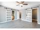 Main bedroom with barn doors, laminate floors and access to bathroom and closet at 911 Pescados Dr, Las Vegas, NV 89123