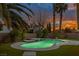 Relaxing kidney-shaped pool and spa, illuminated at dusk at 911 Pescados Dr, Las Vegas, NV 89123