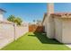 Artificial turf side yard with wood gate and block wall at 911 Pescados Dr, Las Vegas, NV 89123