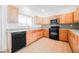 Bright kitchen with light wood cabinets, stainless steel appliances, and tile flooring at 9469 Thatched Sunlight Ct, Las Vegas, NV 89178