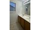 Bathroom with double sinks and wood cabinets at 9540 Birch Basin Ct, Las Vegas, NV 89148