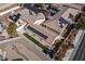 Aerial view of multiple homes featuring solar panels, landscaped yards and desert landscaping at 1069 Appleblossom Time Ave, North Las Vegas, NV 89031