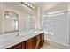 Well-lit primary bathroom with double sinks, shower, and a large mirror at 1069 Appleblossom Time Ave, North Las Vegas, NV 89031