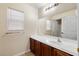 Bathroom featuring single sink vanity with a large mirror and natural lighting at 1069 Appleblossom Time Ave, North Las Vegas, NV 89031