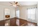 Spacious bedroom with hardwood floors, ceiling fan, and access to the bathroom at 1069 Appleblossom Time Ave, North Las Vegas, NV 89031