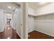 Hallway with wooden floors leading to a walk-in closet with shelving at 1069 Appleblossom Time Ave, North Las Vegas, NV 89031