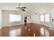 Open concept living room with ceiling fans, hardwood floors, and sheer curtains at 1069 Appleblossom Time Ave, North Las Vegas, NV 89031