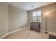 Simple bedroom with a window and a wooden bench at 10960 Prairie Grove Rd, Las Vegas, NV 89179