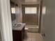 Cozy bathroom with neutral tiling, a vanity with storage, and a shower-tub combination at 1901 Belmont St, North Las Vegas, NV 89030