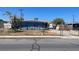 Ranch style home with a blue exterior, fenced yard, and driveway at 1901 Belmont St, North Las Vegas, NV 89030