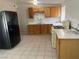 Well-lit kitchen featuring stylish countertops, wooden cabinetry, and modern black appliances at 1901 Belmont St, North Las Vegas, NV 89030