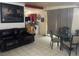 Another living area features a dark leather sofa, dining area and large framed art at 1901 Belmont St, North Las Vegas, NV 89030