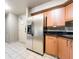 This kitchen features stainless steel appliances, granite countertops, and wooden cabinets at 211 E Flamingo Rd # 412, Las Vegas, NV 89169