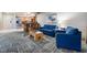 Inviting living room area with comfortable blue seating and an open layout to the kitchen at 211 E Flamingo Rd # 412, Las Vegas, NV 89169