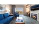 Inviting living space features a fireplace, a comfortable blue sofa, and balcony access at 211 E Flamingo Rd # 412, Las Vegas, NV 89169