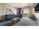 Comfortable living room features stylish seating, a mounted TV, and a balcony with city views at 211 E Flamingo Rd # 412, Las Vegas, NV 89169
