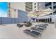 Spacious pool deck with lounge chairs and tables, perfect for relaxing and enjoying the outdoors at 211 E Flamingo Rd # 412, Las Vegas, NV 89169