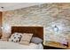 Main bedroom with stone accent wall and pendant lights at 2410 Doherty Way, Henderson, NV 89014