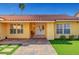 A home's entrance features a stone walkway and manicured lawn at 2410 Doherty Way, Henderson, NV 89014