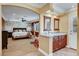 Spacious primary suite with stone accent wall, ceiling fan, and en-suite bathroom with dual sinks at 2410 Doherty Way, Henderson, NV 89014