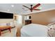 Main bedroom with carpet, ceiling fan, a couch and a window with plantation shutters at 2410 Doherty Way, Henderson, NV 89014