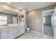 Bright bathroom features a double sink vanity, a toilet, and access to the bedroom at 2436 Padulle Pl, Henderson, NV 89044