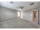 Neutral bedroom with carpet, ceiling fan, and doorway to ensuite bathroom and walk-in closet at 2436 Padulle Pl, Henderson, NV 89044