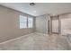 Bright and airy living room with tile floors and multiple windows leading to the kitchen at 2436 Padulle Pl, Henderson, NV 89044