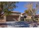 Front view of the house showcasing the garage and landscaping at 2437 Desert Butte Dr, Las Vegas, NV 89134