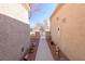 Exterior walkway between buildings leading to the front door with desert landscaping at 2437 Desert Butte Dr, Las Vegas, NV 89134