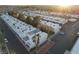 Aerial view of a well-maintained townhome community with palm trees, ample parking, and lush landscaping at 2638 Aracatuba Ave, Las Vegas, NV 89121
