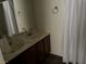 Bathroom featuring a dual sink vanity, large mirror, and shower with curtain at 2638 Aracatuba Ave, Las Vegas, NV 89121
