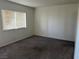 Carpeted bedroom featuring a large window and neutral walls at 2638 Aracatuba Ave, Las Vegas, NV 89121