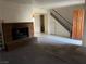 View of living room featuring a brick fireplace and staircase at 2638 Aracatuba Ave, Las Vegas, NV 89121