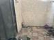 An outdoor patio with red brick tiles and some yard tools at 2638 Aracatuba Ave, Las Vegas, NV 89121