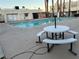 Poolside view with tables and benches, perfect for relaxation and social gatherings at 2638 Aracatuba Ave, Las Vegas, NV 89121