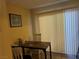 Small dining area with a simple table and chairs near sliding door at 2663 Aracatuba Ave, Las Vegas, NV 89121
