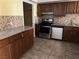 Kitchen featuring granite counters, brown cabinets, and stainless steel appliances at 2663 Aracatuba Ave, Las Vegas, NV 89121