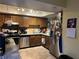 Kitchen with wood cabinets, granite counters, and stainless steel appliances at 2663 Aracatuba Ave, Las Vegas, NV 89121