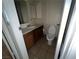 A small bathroom has a toilet, wood vanity with sink, tile floor, and painted walls at 2686 Ruthe Duarte Ave, Las Vegas, NV 89121